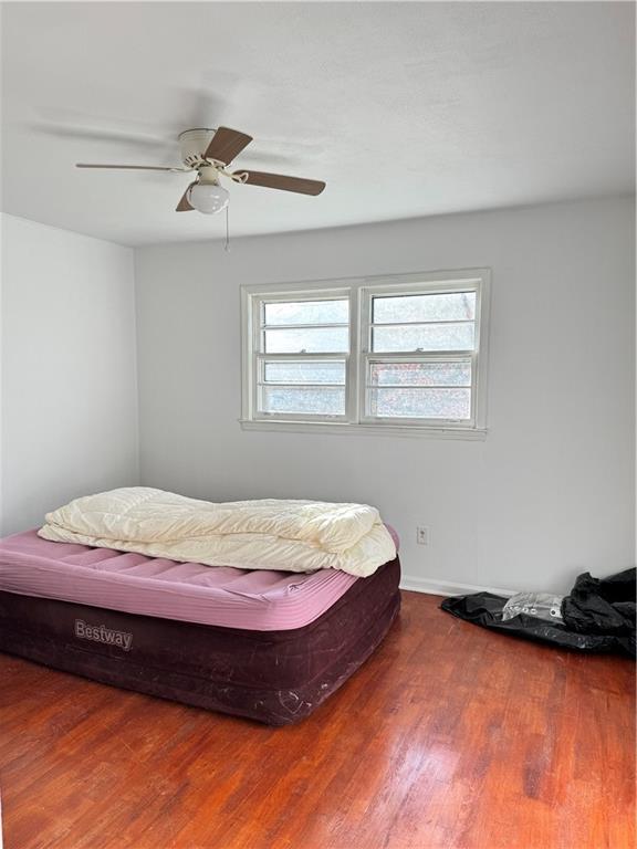 5297 Cardinal Lane Northwest Lilburn, GA 30047 - Photo 18 of 31 a bed sitting in a bedroom next to a window