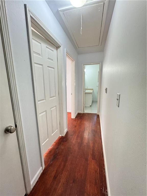 5297 Cardinal Lane Northwest Lilburn, GA 30047 - Photo 23 of 31 a view of a hallway with wooden floor and a bathroom