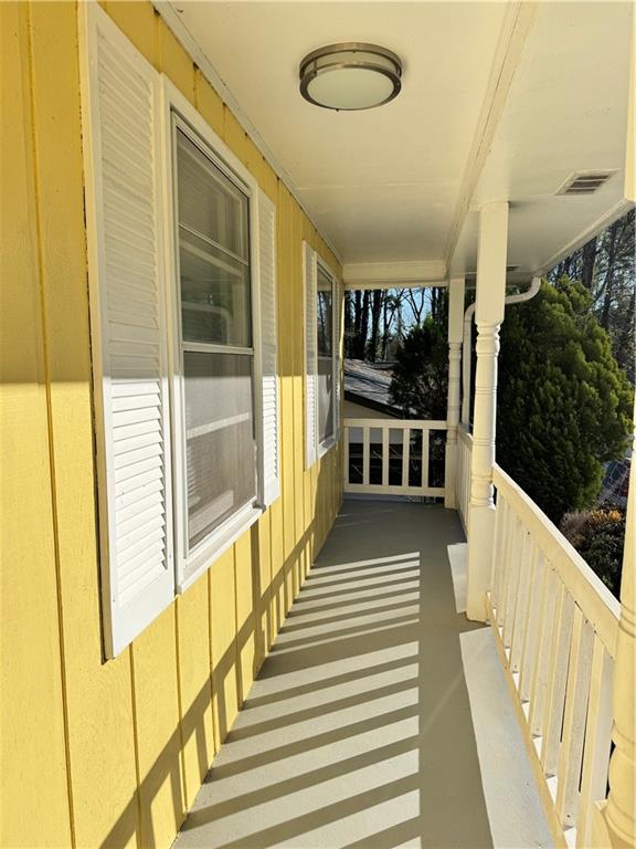 5297 Cardinal Lane Northwest Lilburn, GA 30047 - Photo 3 of 31 a view of a balcony with wooden floor and windows