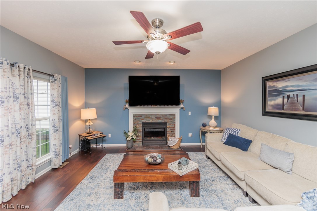 32883 Walnut Drive Avon, OH 44011 - Photo 3 of 34 Living room featuring ceiling fan, dark hardwood / wood-style flooring, a healthy amount of sunlight, and a fireplace