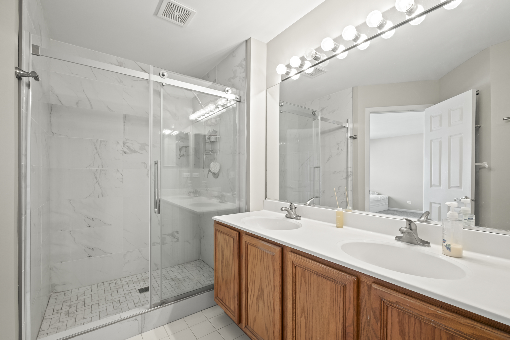 7917 Windsor Drive Darien, IL 60561 - Photo 13 of 31 a bathroom with a double vanity sink mirror and shower