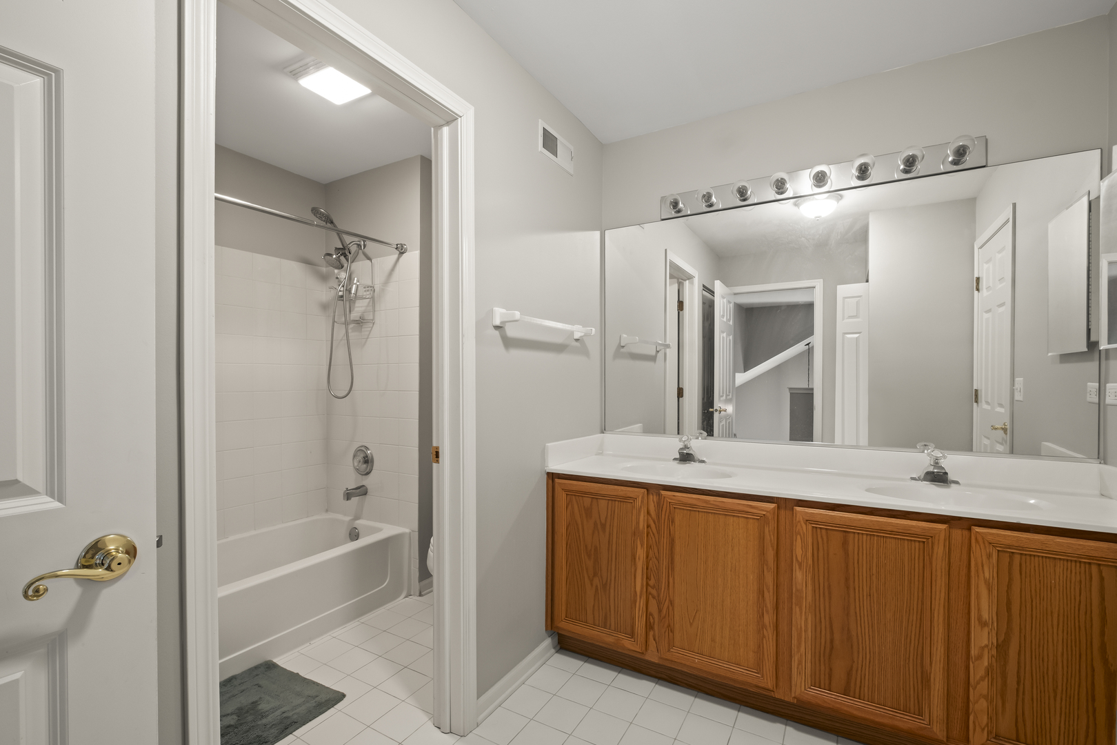 7917 Windsor Drive Darien, IL 60561 - Photo 17 of 31 a bathroom with a double vanity sink mirror and bathtub