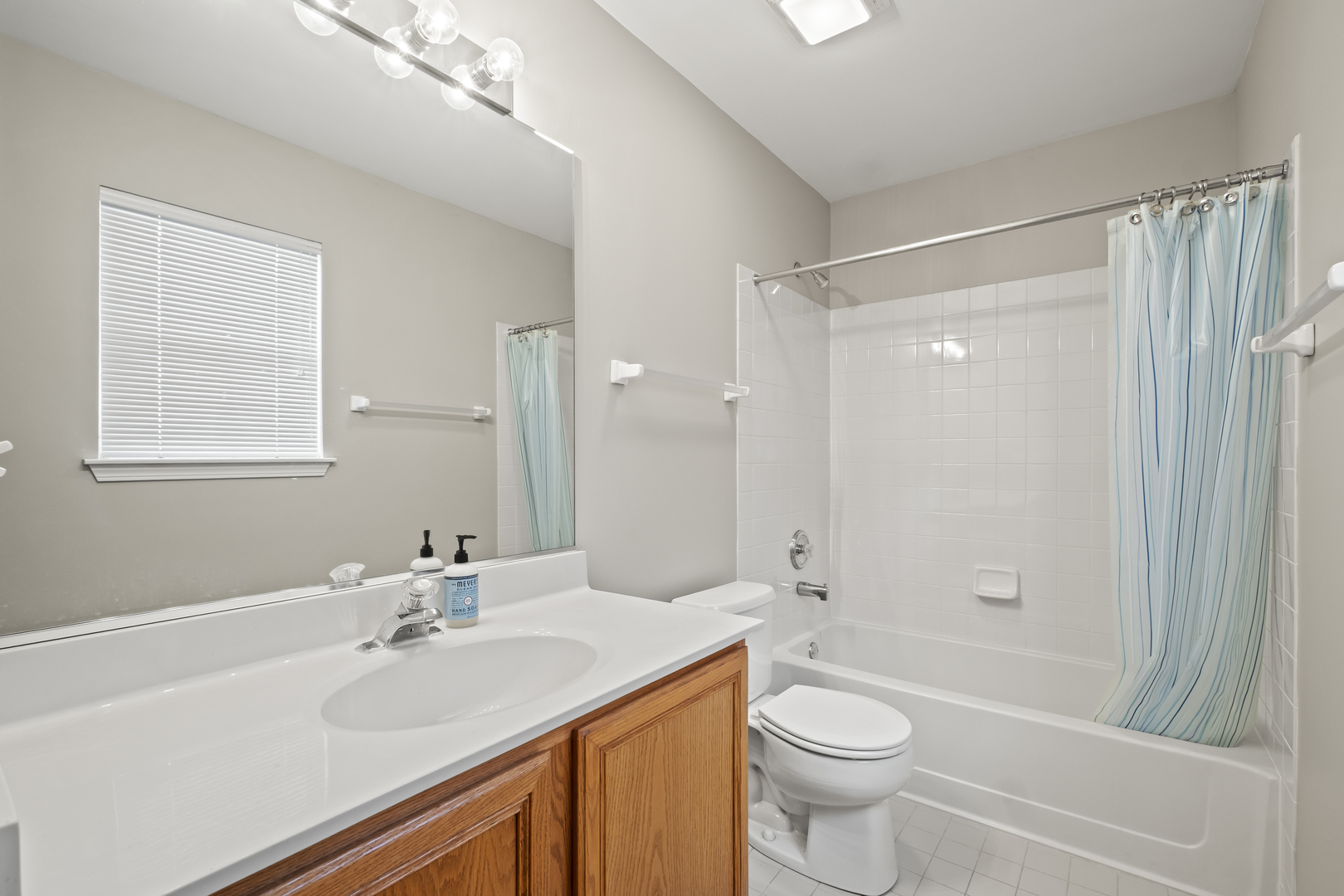 7917 Windsor Drive Darien, IL 60561 - Photo 23 of 31 a bathroom with a sink a toilet and shower