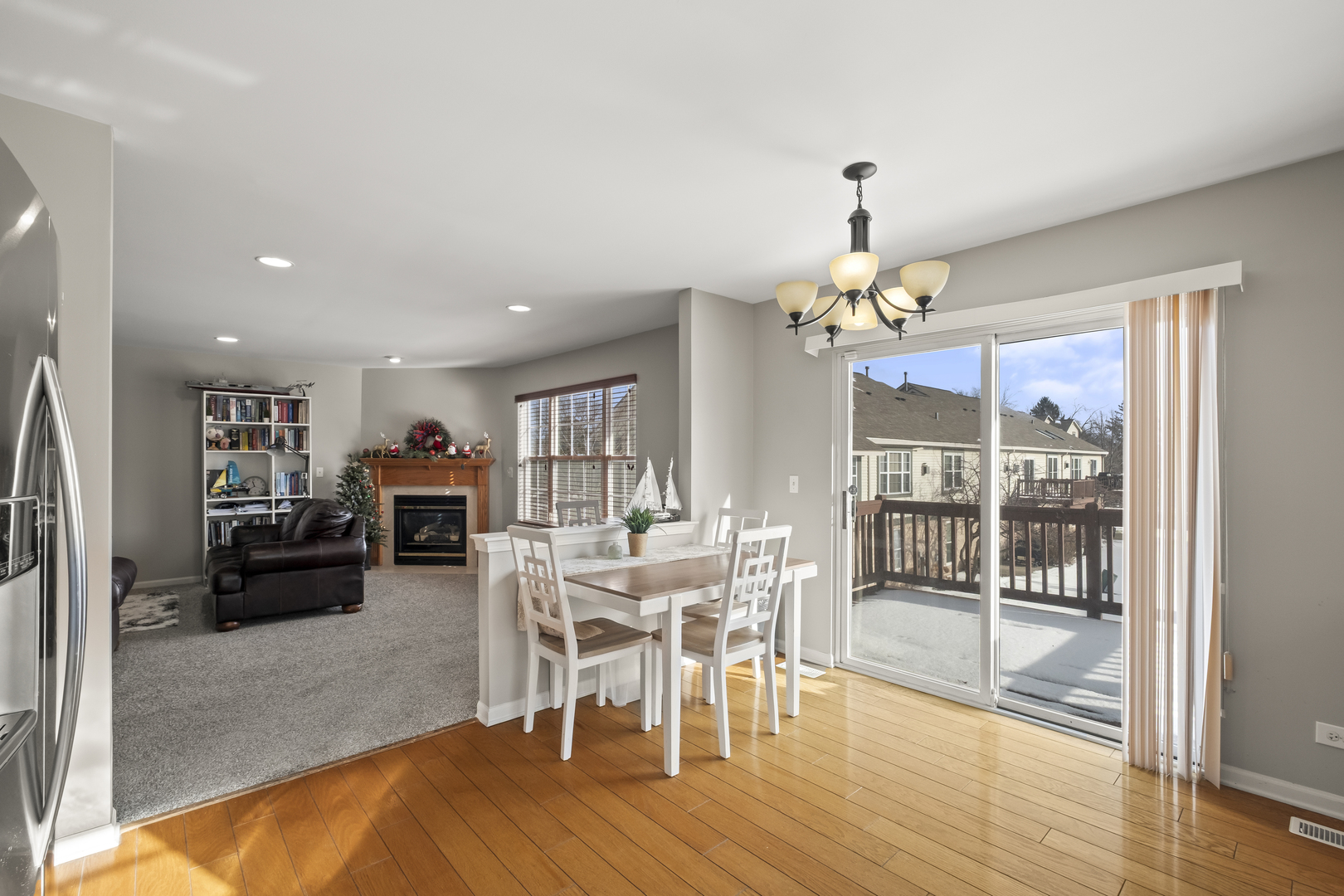 7917 Windsor Drive Darien, IL 60561 - Photo 7 of 31 a dining room with furniture a chandelier and wooden floor