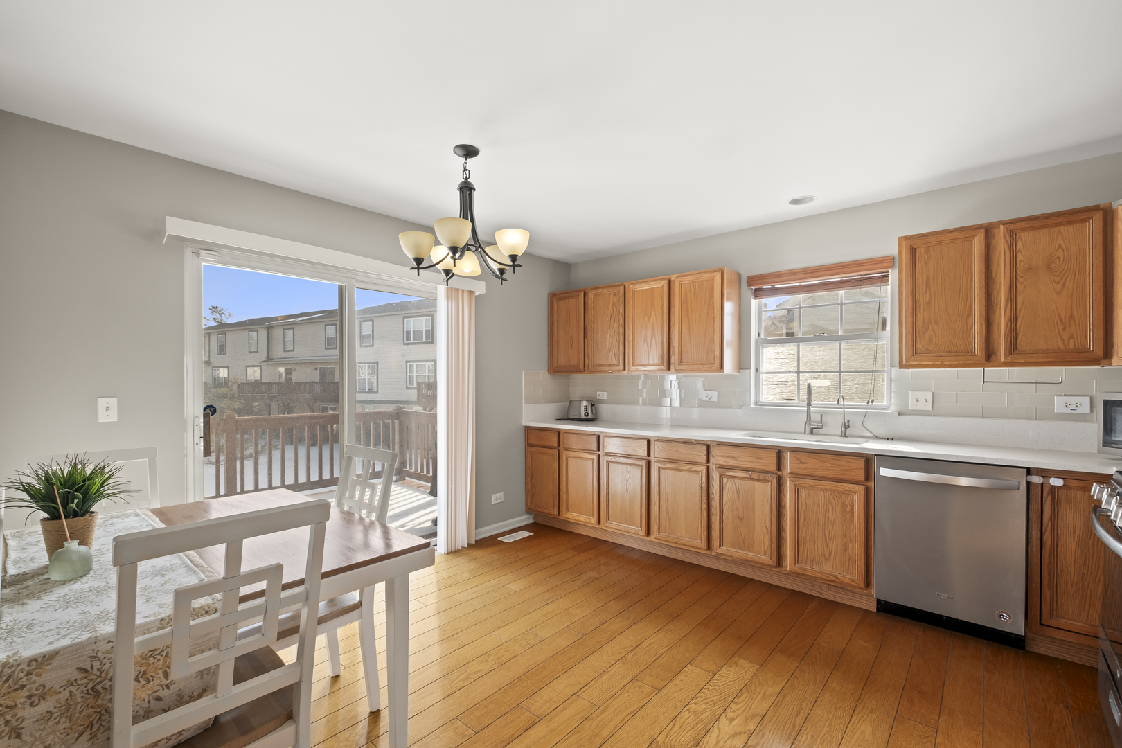 7917 Windsor Drive Darien, IL 60561 - Photo 9 of 31 a large kitchen with kitchen island granite countertop wooden floor a counter space and stainless steel appliances
