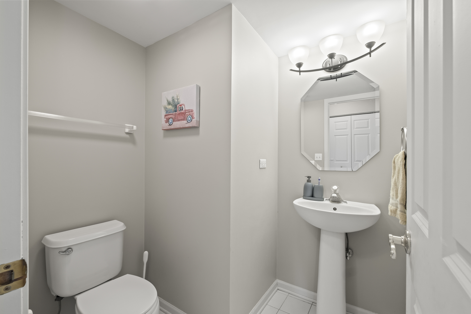 7917 Windsor Drive Darien, IL 60561 - Photo 10 of 31 a bathroom with a sink toilet and a mirror