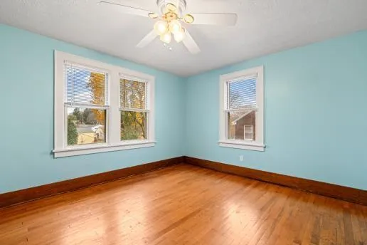 a kitchen with stainless steel appliances granite countertop a refrigerator a sink dishwasher and wooden cabinets with wooden floor