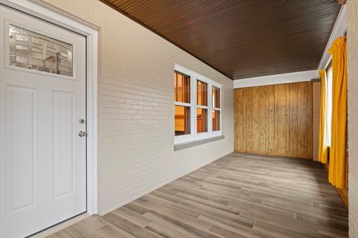1611 Roemer Boulevard Farrell, PA 16121 - Photo 4 of 35 a view of an empty room with wooden floor and a window