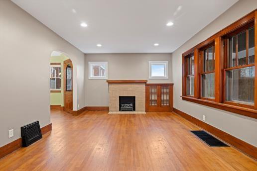 1611 Roemer Boulevard Farrell, PA 16121 - Photo 7 of 35 a view of an empty room with wooden floor and a window