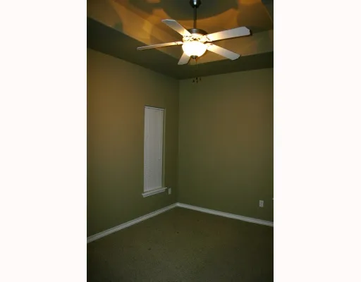 a picture of a room with a ceiling fan