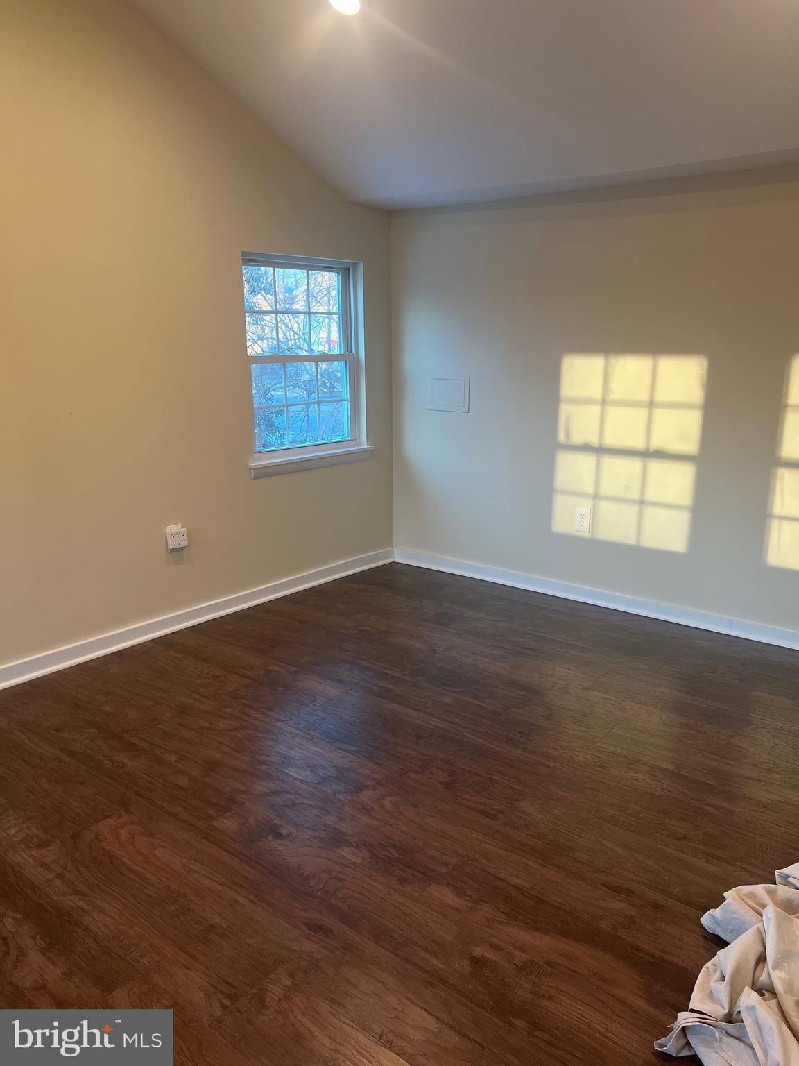 5732 Bugler Street Capitol Heights, MD 20743 - Photo 11 of 23 an empty room with wooden floor and windows