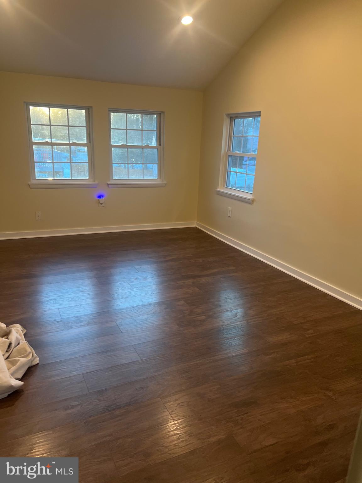 5732 Bugler Street Capitol Heights, MD 20743 - Photo 14 of 23 a view of an empty room with wooden floor and a window