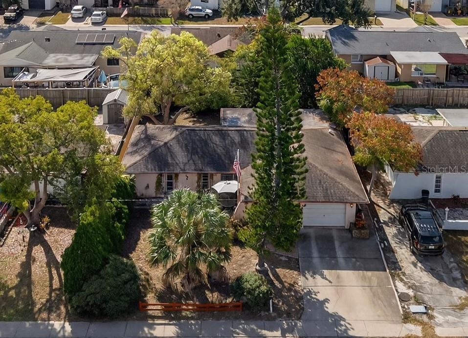an aerial view of multiple houses with yard