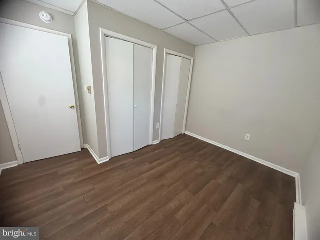 an empty room with wooden floor