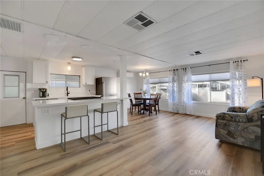 840 Foothill, Unit 27 Azusa, CA 91702 - Photo 8 of 30 a living room with furniture a dining table and kitchen view
