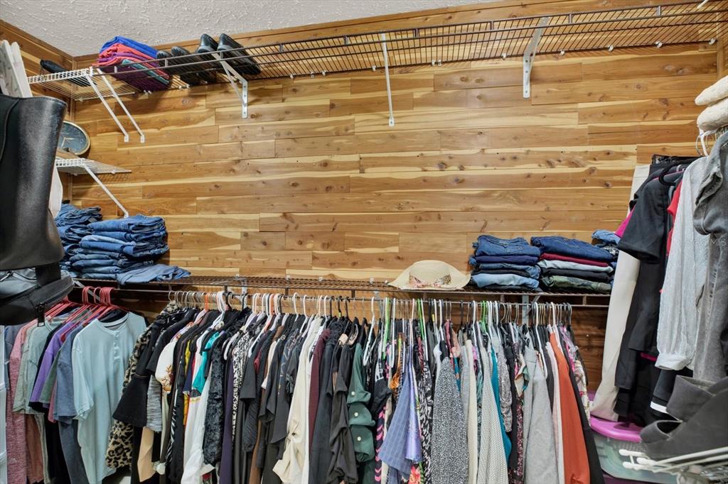 7487 River Country Drive Weeki Wachee, FL 34607 - Photo 28 of 53 a view of walk in closet with clothes