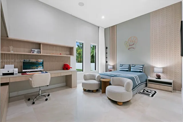 a bedroom with furniture and a large window