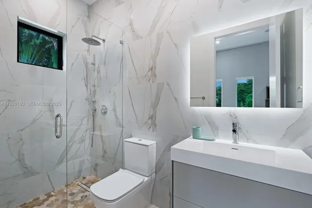 a bathroom with a sink toilet and shower