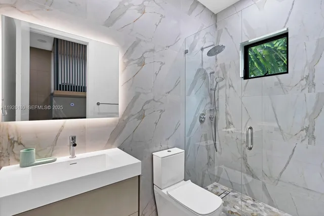 a bathroom with a sink toilet and shower