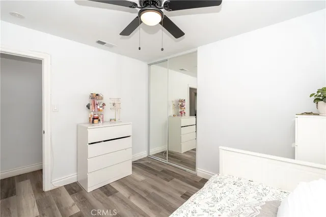 a bedroom with a bed and cabinets