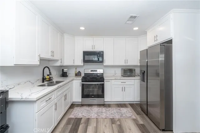 a kitchen with white cabinets and white appliances