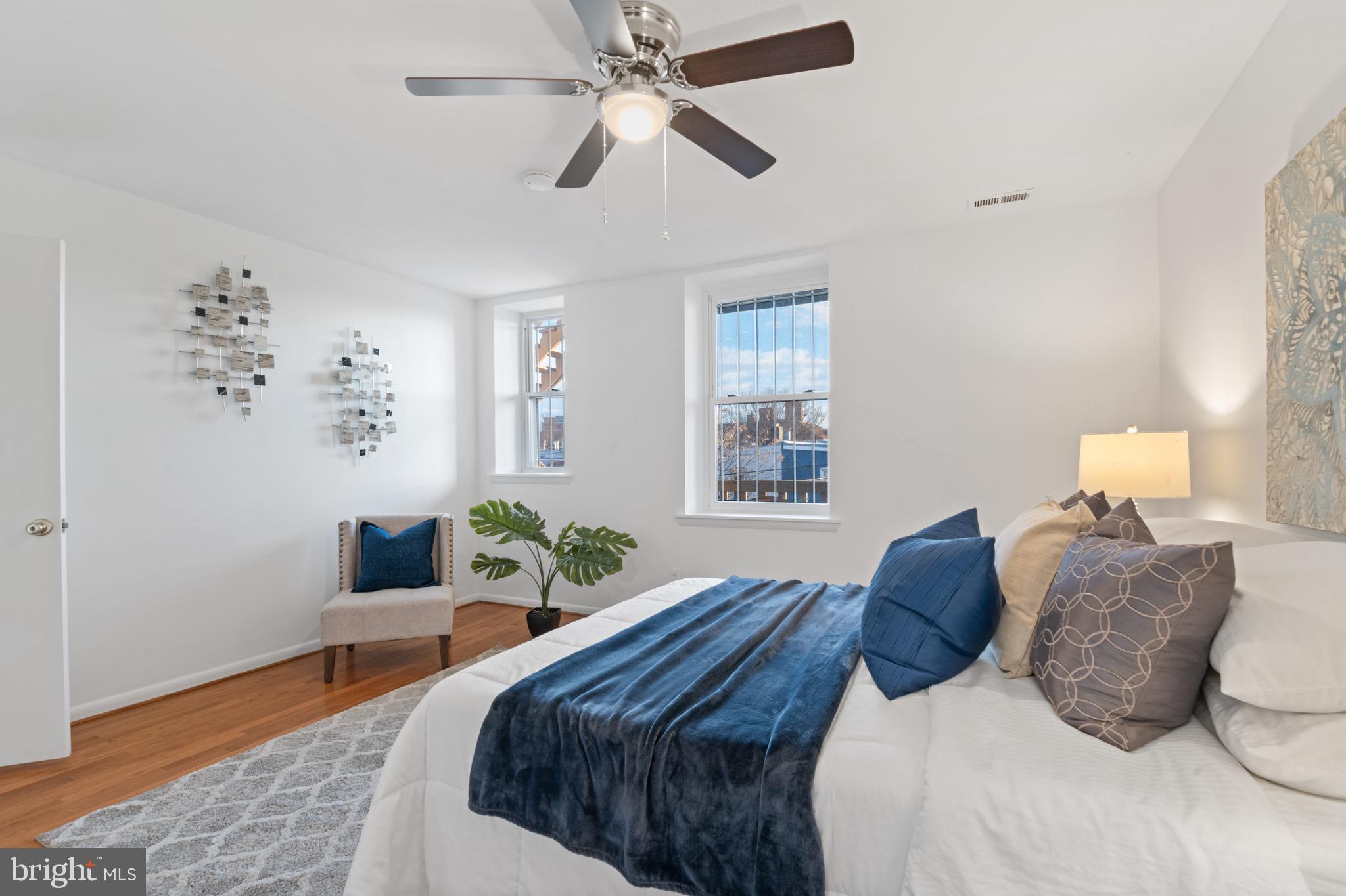 36 Q Street Northwest Washington, DC 20001 - Photo 12 of 40 a bedroom with a bed lamp and a potted plant