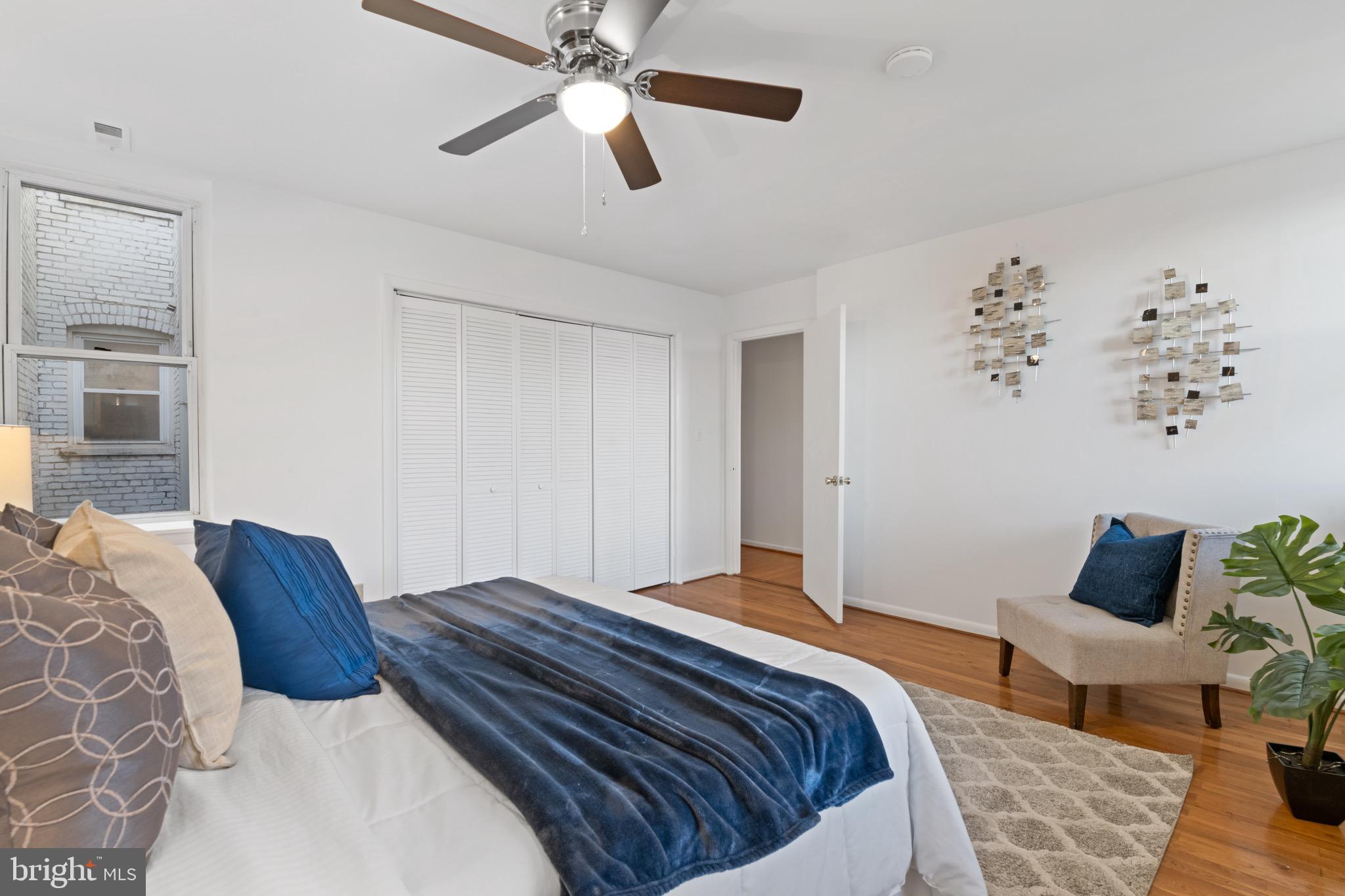 36 Q Street Northwest Washington, DC 20001 - Photo 13 of 40 a bedroom with a large bed and a chandelier fan