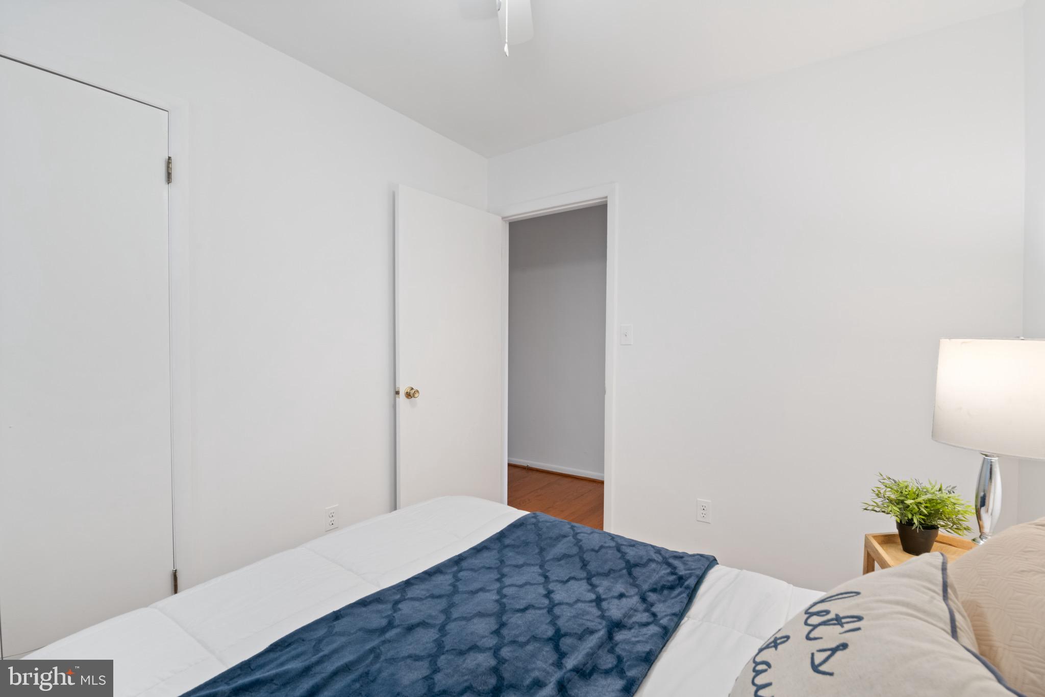 36 Q Street Northwest Washington, DC 20001 - Photo 15 of 40 a bedroom with a bed and a lamp
