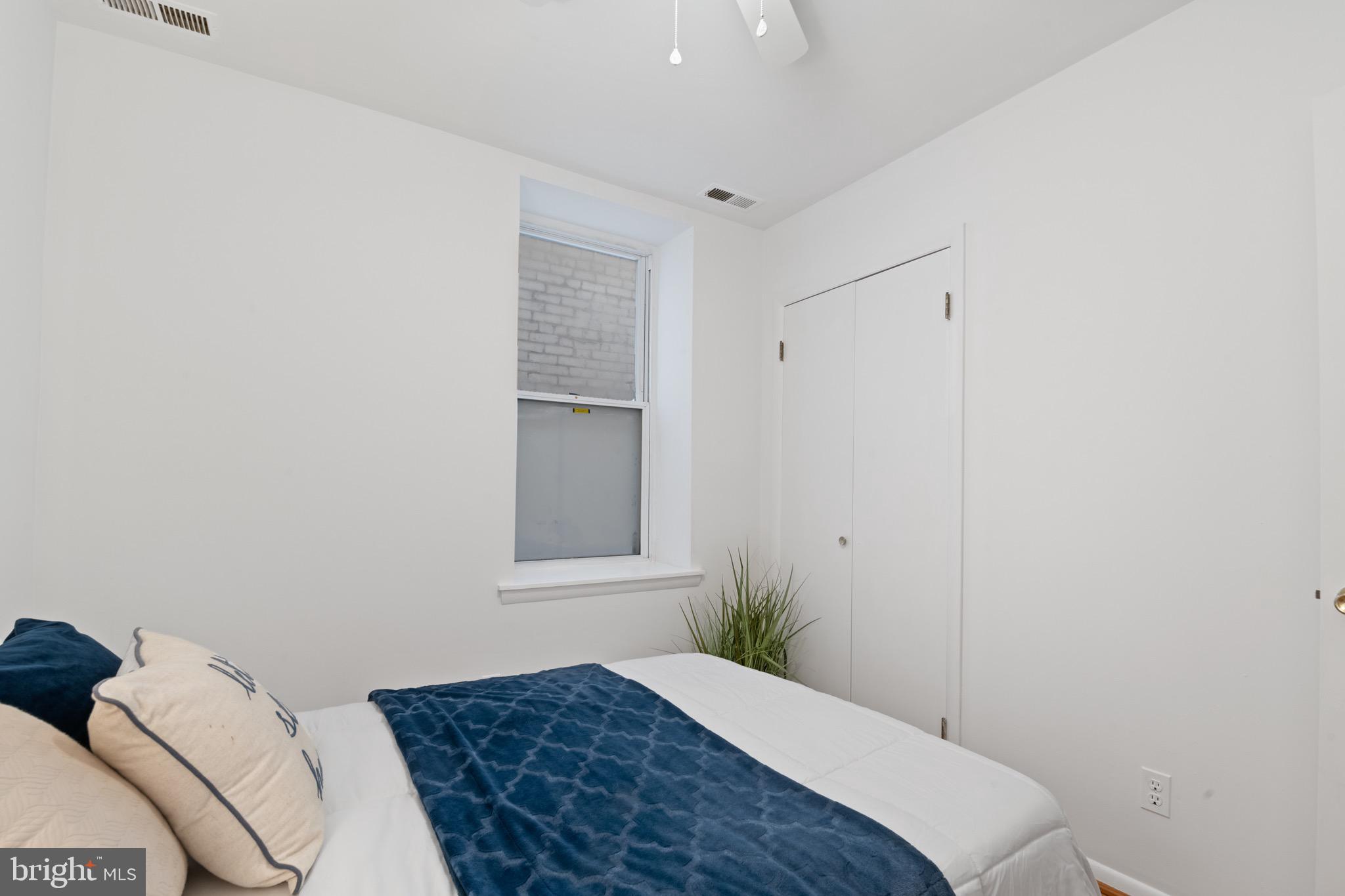 36 Q Street Northwest Washington, DC 20001 - Photo 16 of 40 a bedroom with a bed and a window