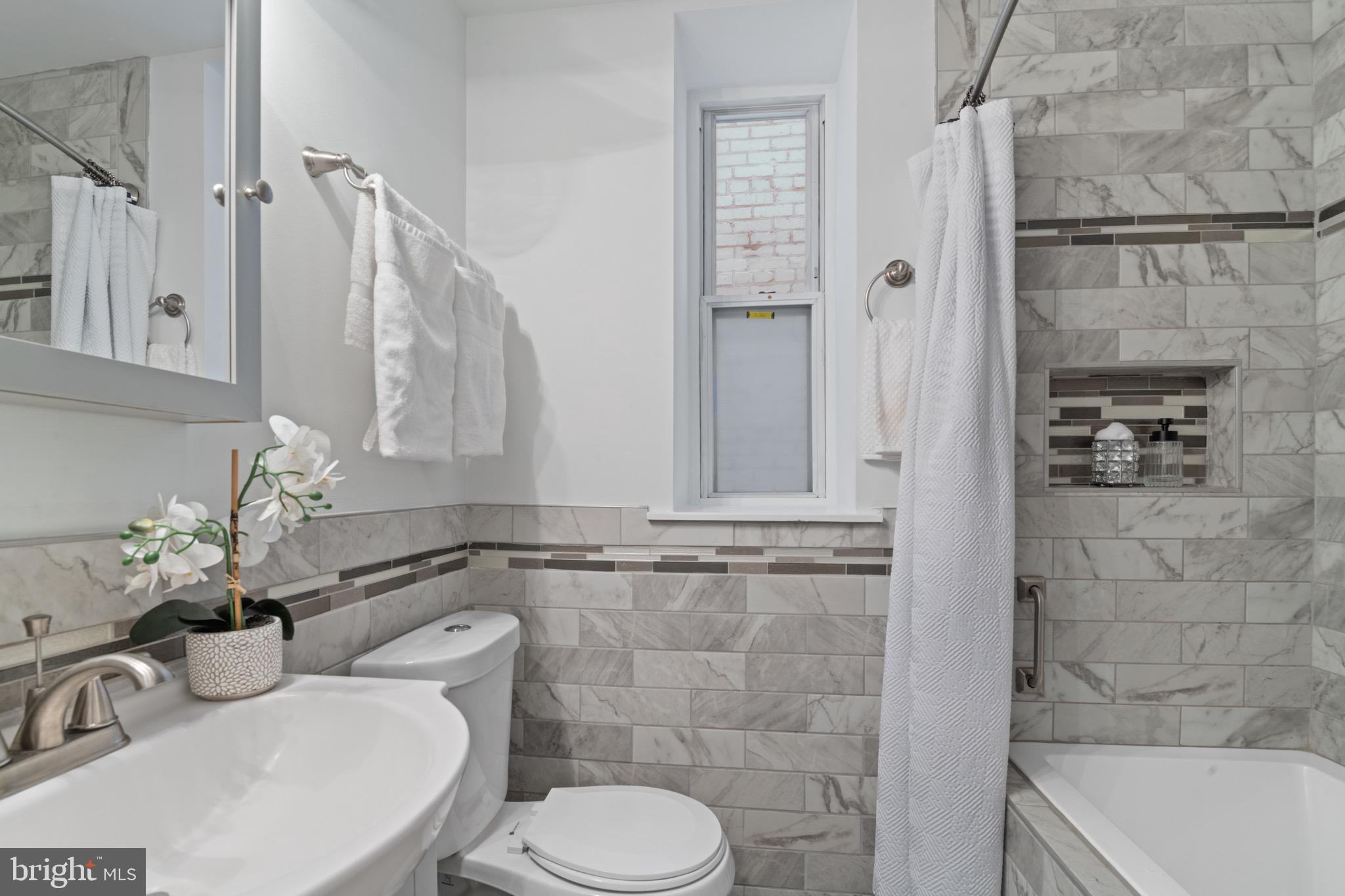 36 Q Street Northwest Washington, DC 20001 - Photo 17 of 40 a bathroom with a sink toilet and shower