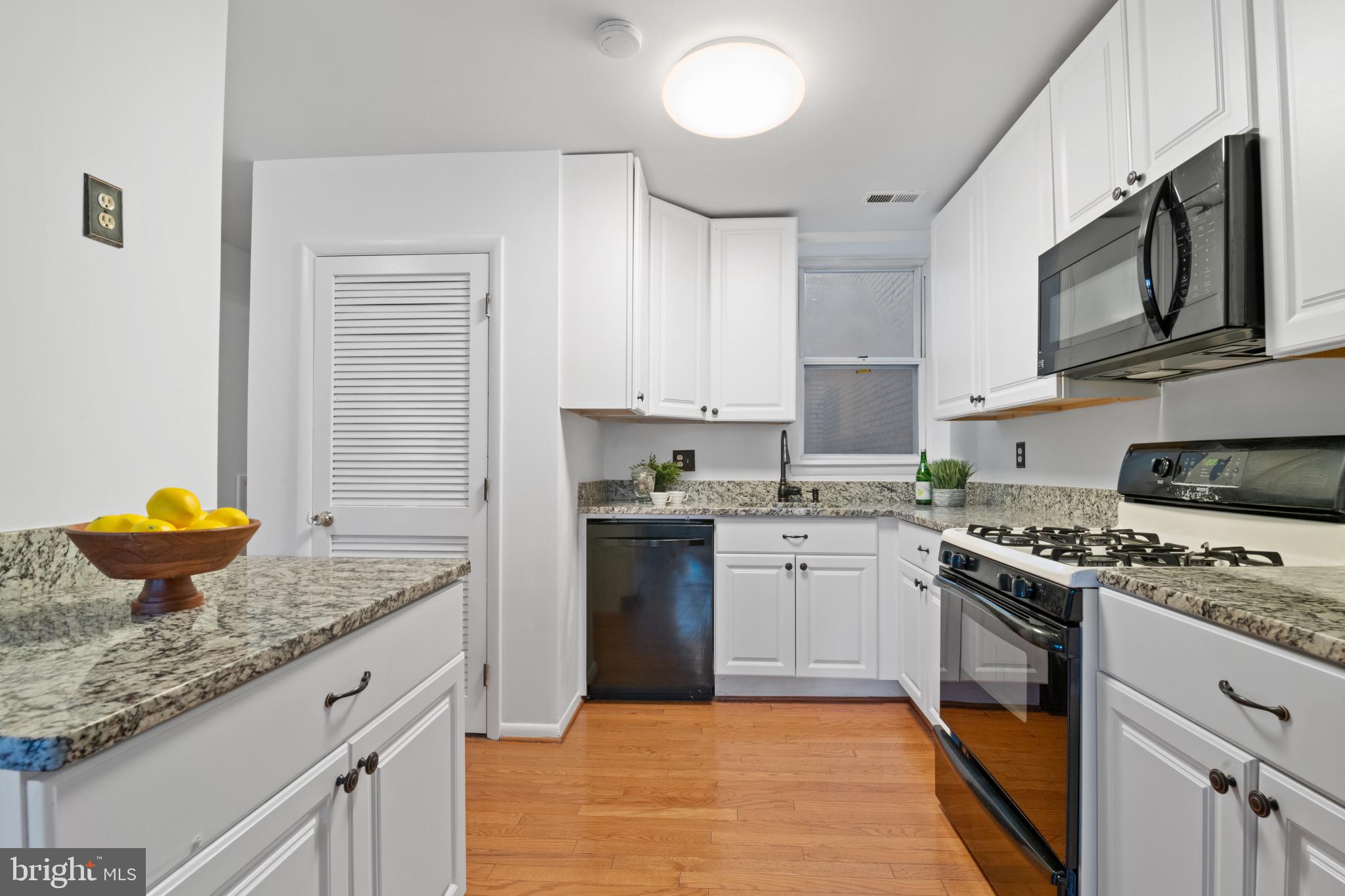 36 Q Street Northwest Washington, DC 20001 - Photo 21 of 40 a kitchen with stainless steel appliances granite countertop a stove a sink and a microwave