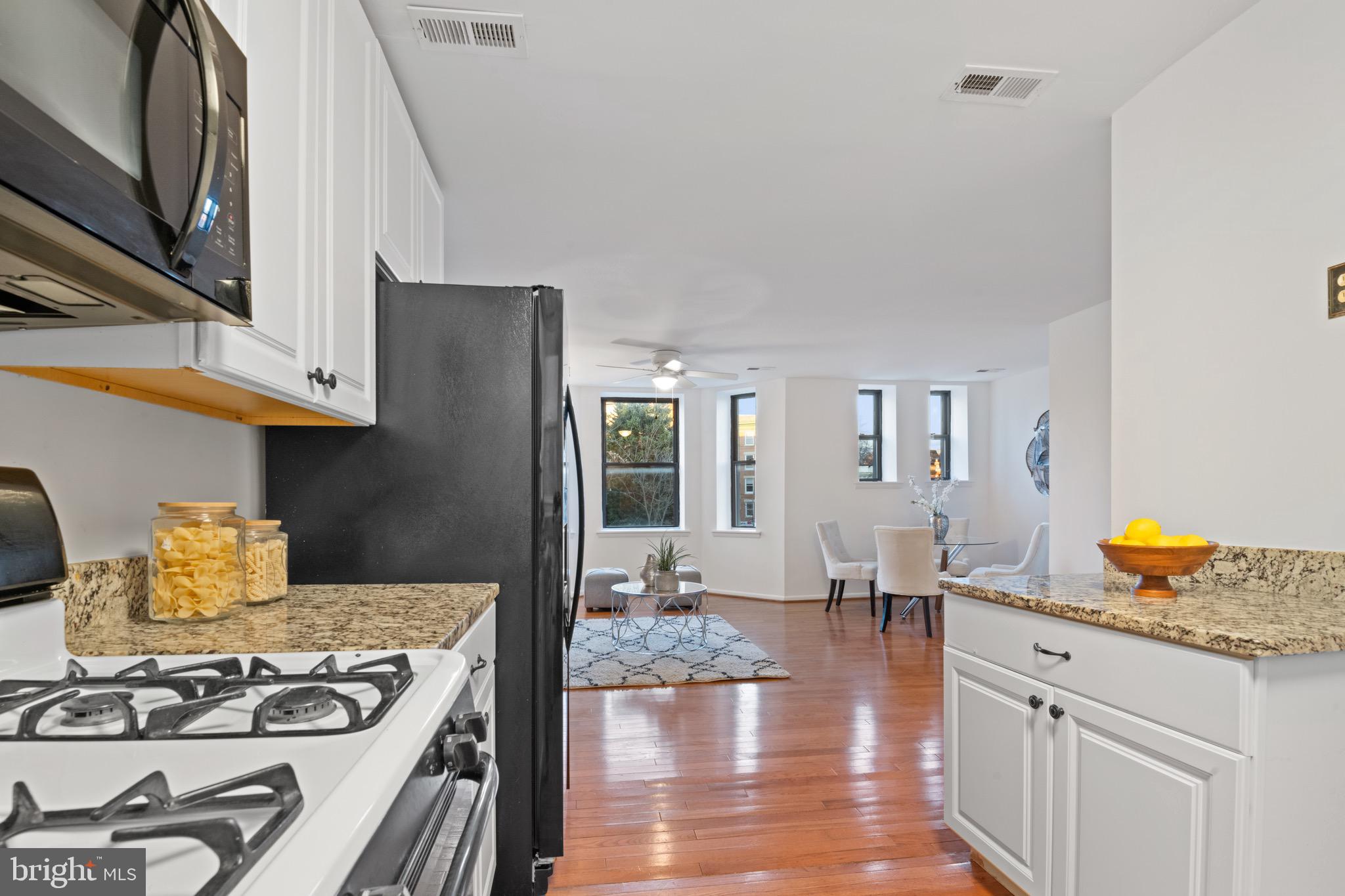 36 Q Street Northwest Washington, DC 20001 - Photo 22 of 40 a kitchen with a stove and white cabinets