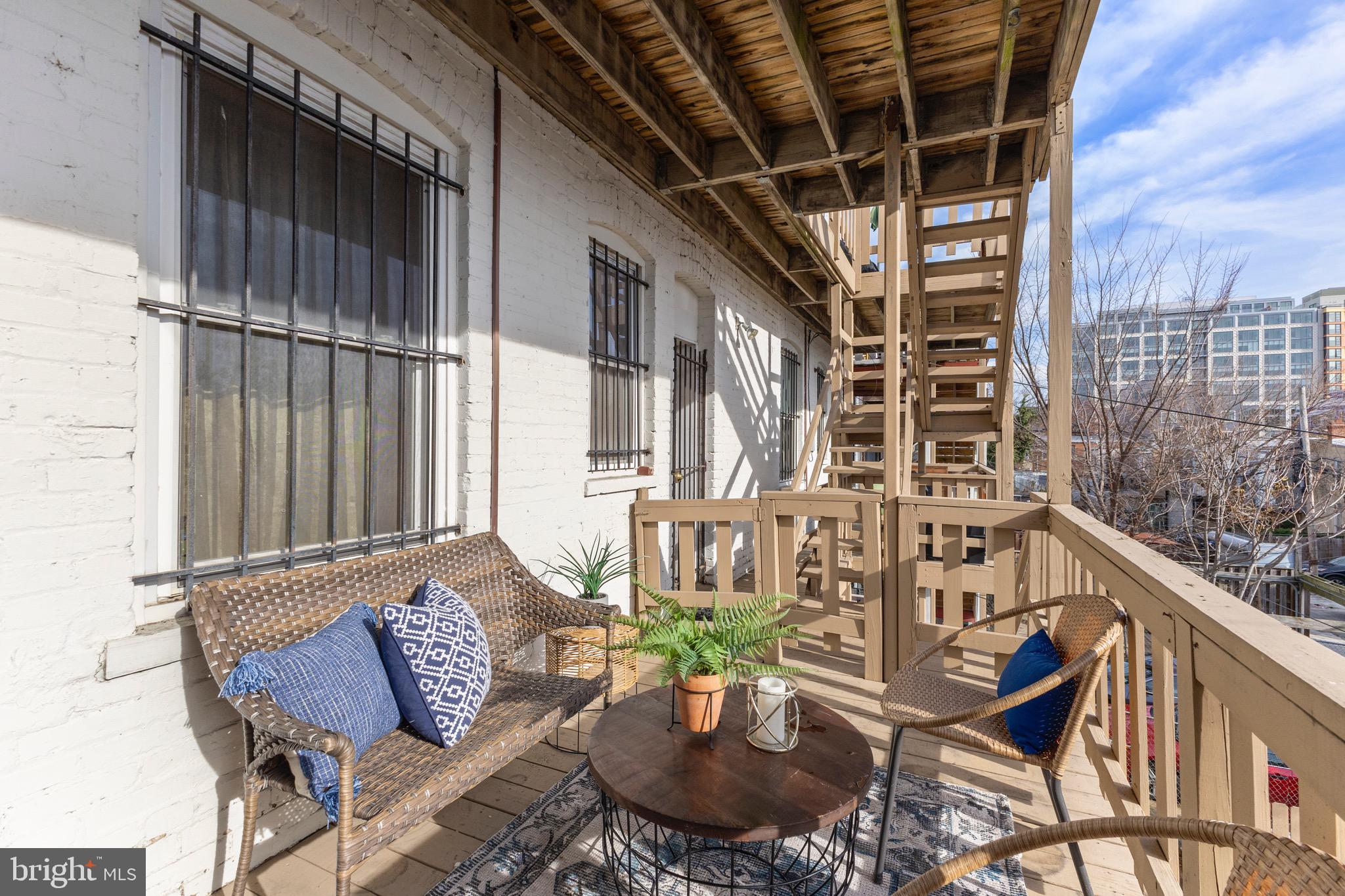 36 Q Street Northwest Washington, DC 20001 - Photo 28 of 40 a balcony with couple of chairs and a wooden floor
