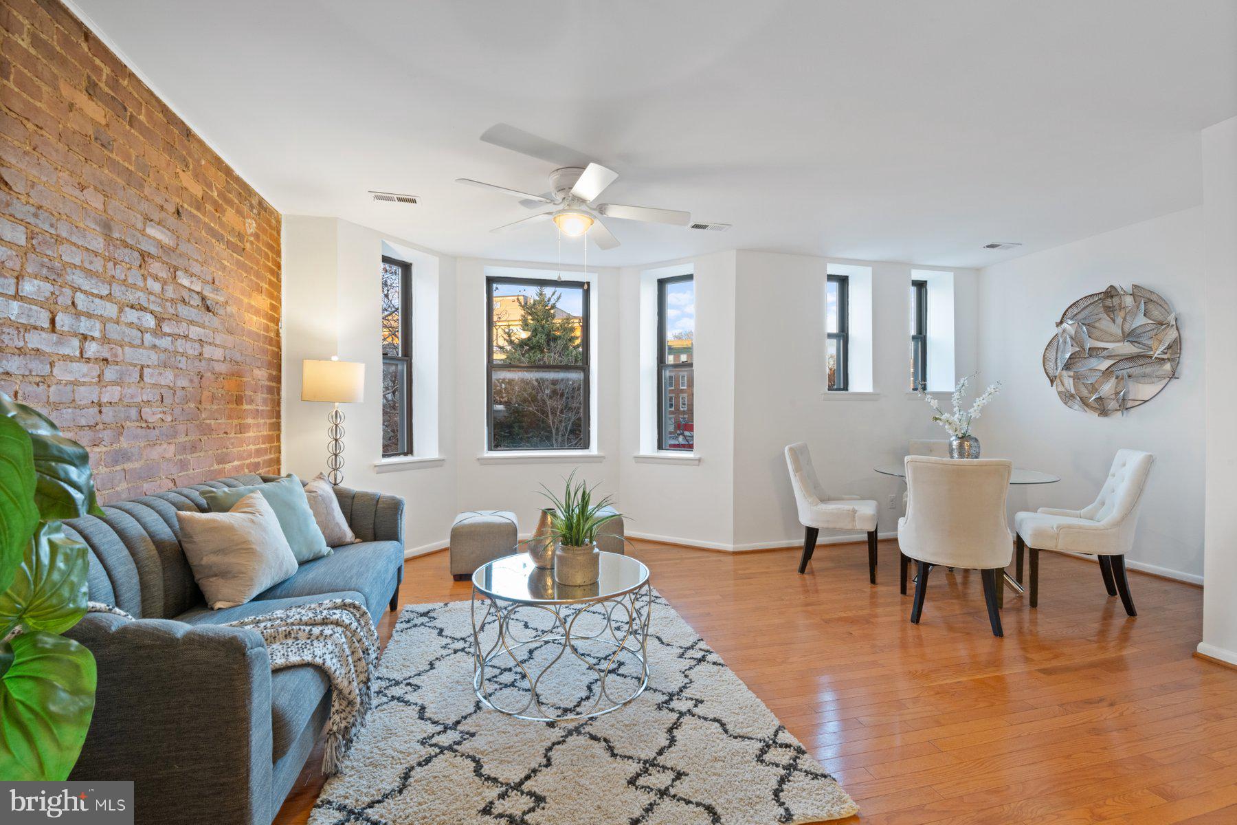 36 Q Street Northwest Washington, DC 20001 - Photo 4 of 40 a living room with furniture and a large window