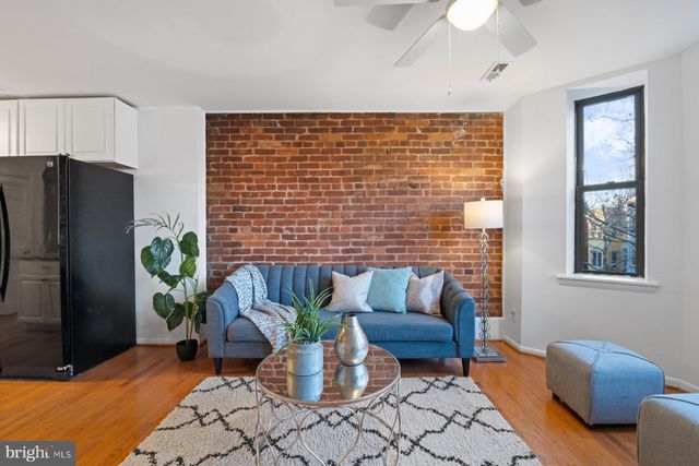 a view of a livingroom with furniture and a potted plant