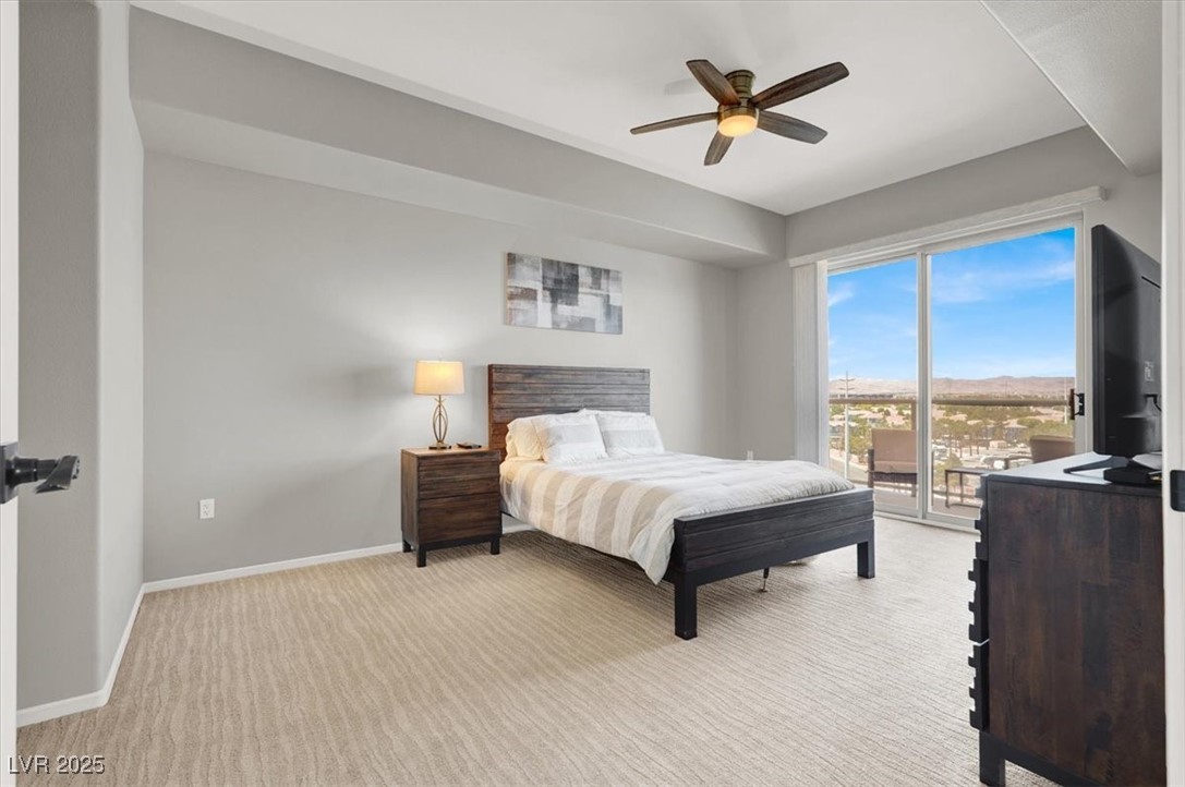 8255 South Las Vegas Boulevard, Unit 722 Las Vegas, NV 89123 - Photo 13 of 40 Bedroom featuring access to outside, light carpet, and a ceiling fan