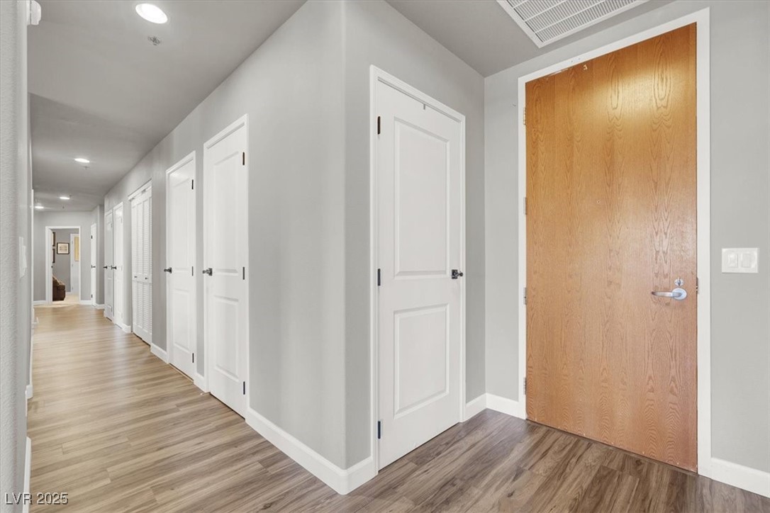 8255 South Las Vegas Boulevard, Unit 722 Las Vegas, NV 89123 - Photo 17 of 40 Hallway featuring wood finished floors and recessed lighting