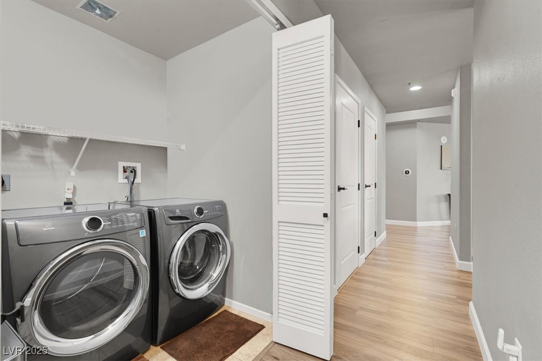 8255 South Las Vegas Boulevard, Unit 722 Las Vegas, NV 89123 - Photo 19 of 40 Laundry area featuring washer and clothes dryer and light wood-style floors