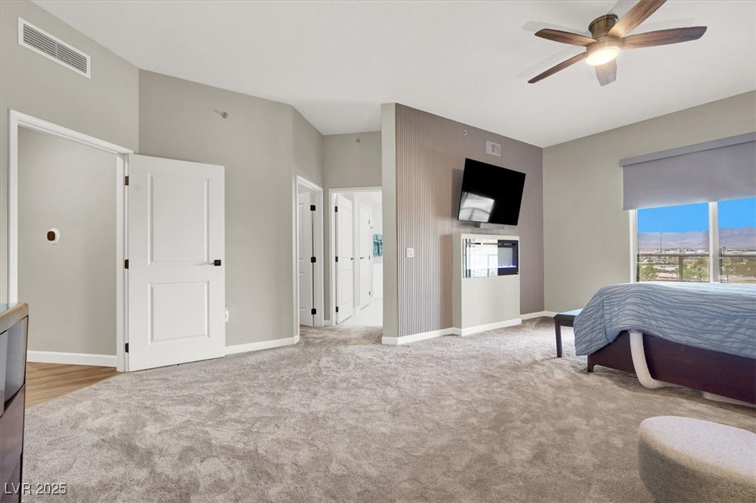 8255 South Las Vegas Boulevard, Unit 722 Las Vegas, NV 89123 - Photo 24 of 40 Carpeted bedroom featuring multiple windows and ceiling fan