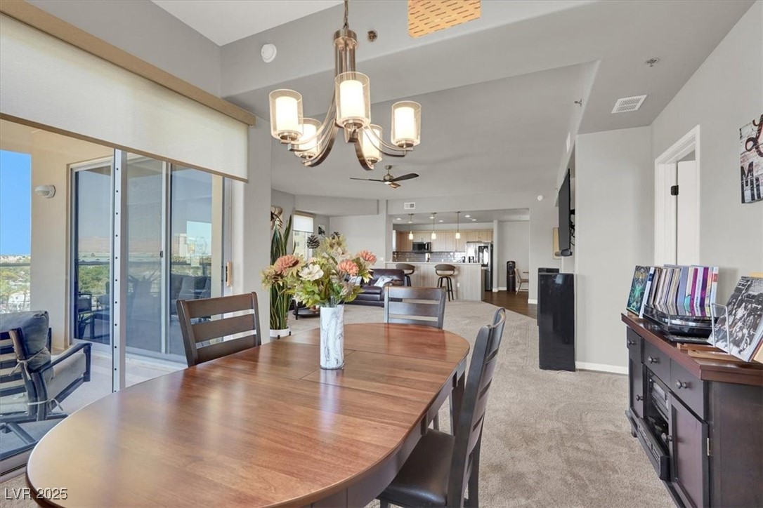 8255 South Las Vegas Boulevard, Unit 722 Las Vegas, NV 89123 - Photo 9 of 40 Dining area with a chandelier and light carpet