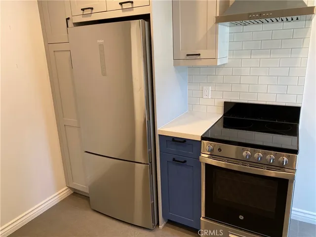 a kitchen with a refrigerator stove and cabinets