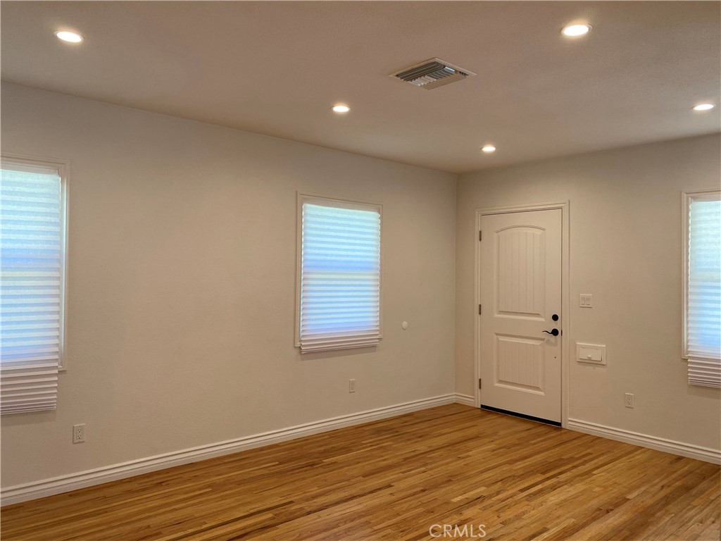 1125 North Verdugo Road Glendale, CA 91206 - Photo 6 of 7 an empty room with wooden floor and windows