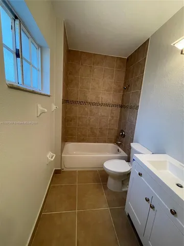 a bathroom with a toilet a sink and bathtub