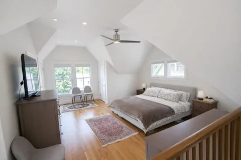 a bedroom with a bed couch and window