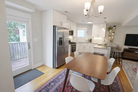 a kitchen with stainless steel appliances granite countertop a sink refrigerator and microwave