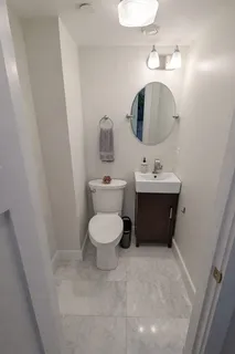 a bathroom with a toilet sink and mirror