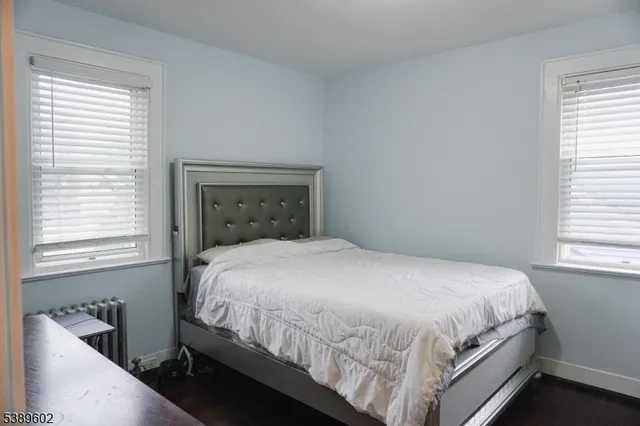 a large bed sitting in a bedroom next to a window