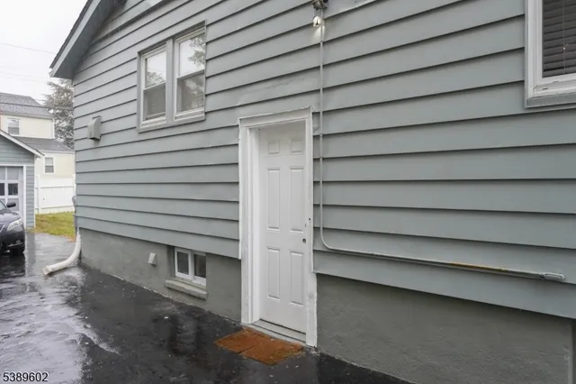 a view of a house with a door and wooden walls
