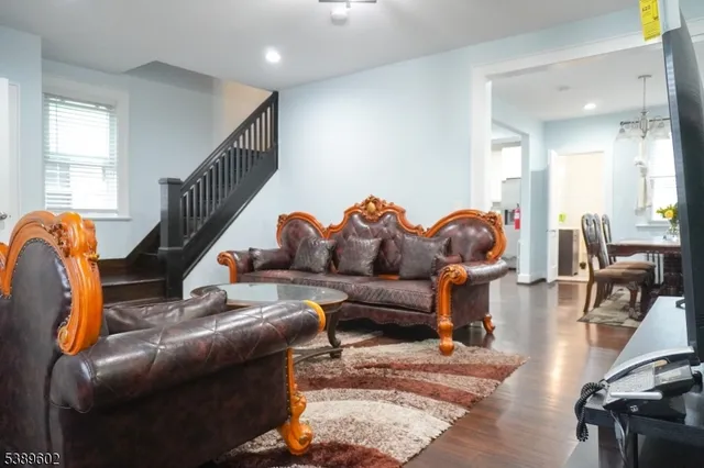 a living room with furniture gym equipment and a windows