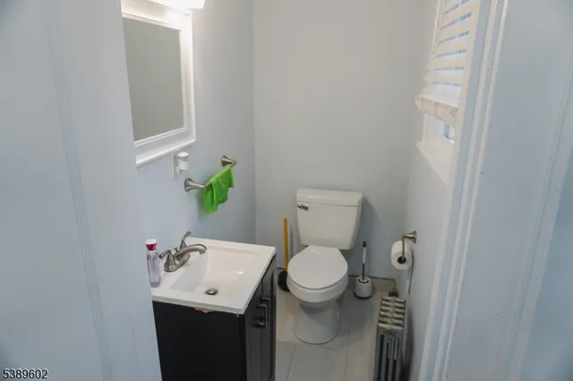 a bathroom with a sink toilet and a mirror